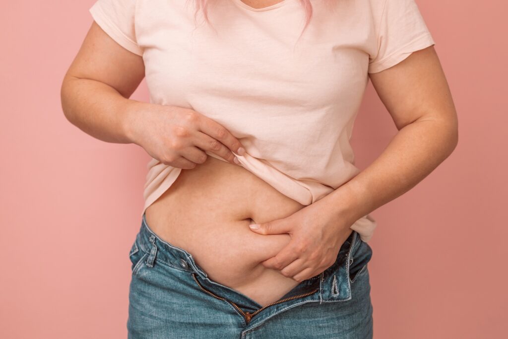 Adult woman holding belly fat in jeans 2026 03 24 21 31 13 utc