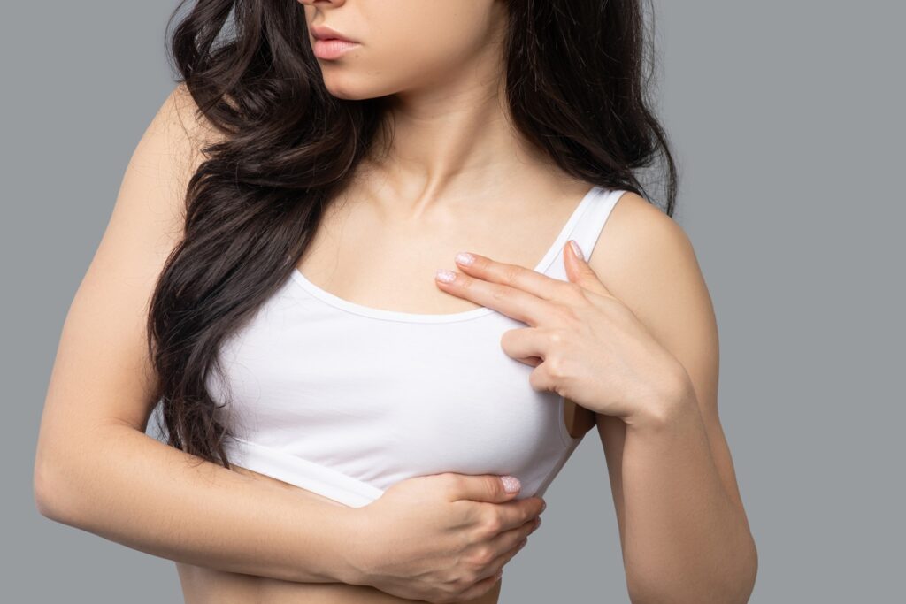 Close up picture of a girlmeasuring her breast